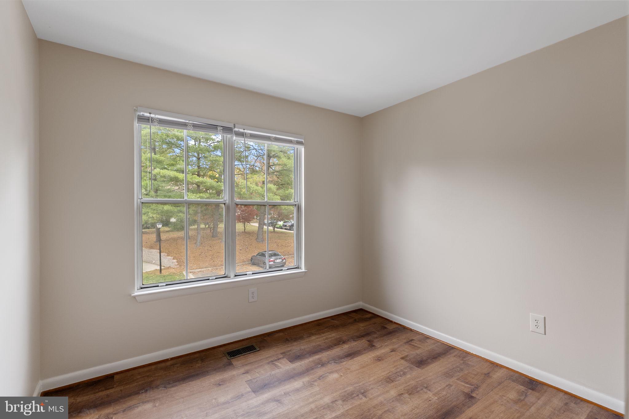 4 Waterside Court Germantown, MD 20874 - Photo 24 of 37 a view of an empty room with wooden floor and a window
