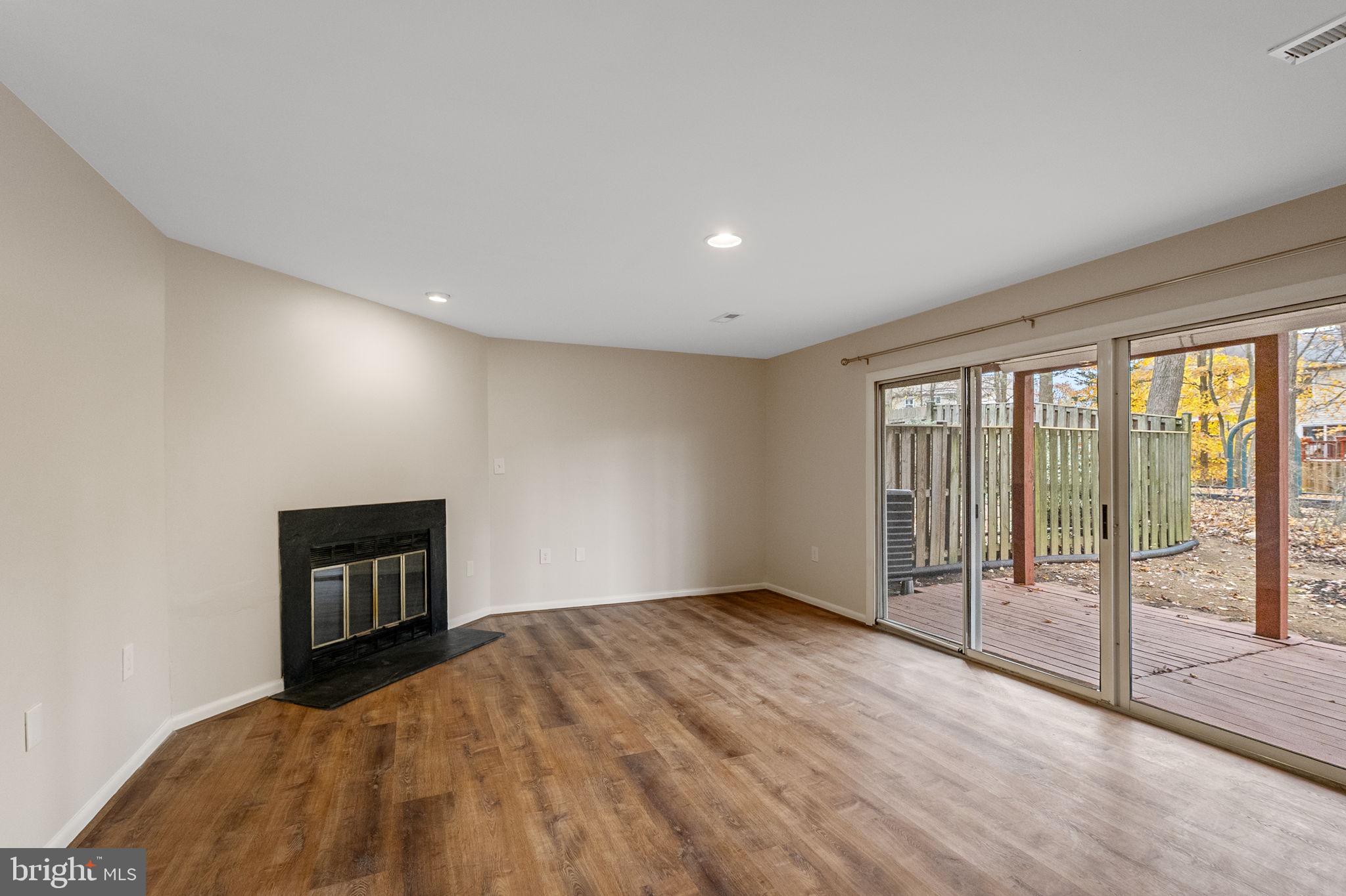 4 Waterside Court Germantown, MD 20874 - Photo 27 of 37 a view of an empty room with wooden floor and a window