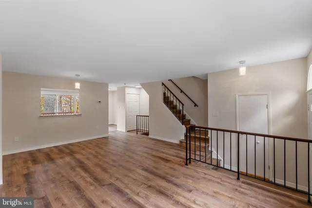 a view of an entryway with wooden floor