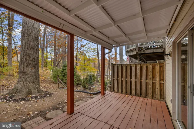a view of balcony with wooden fence and floor