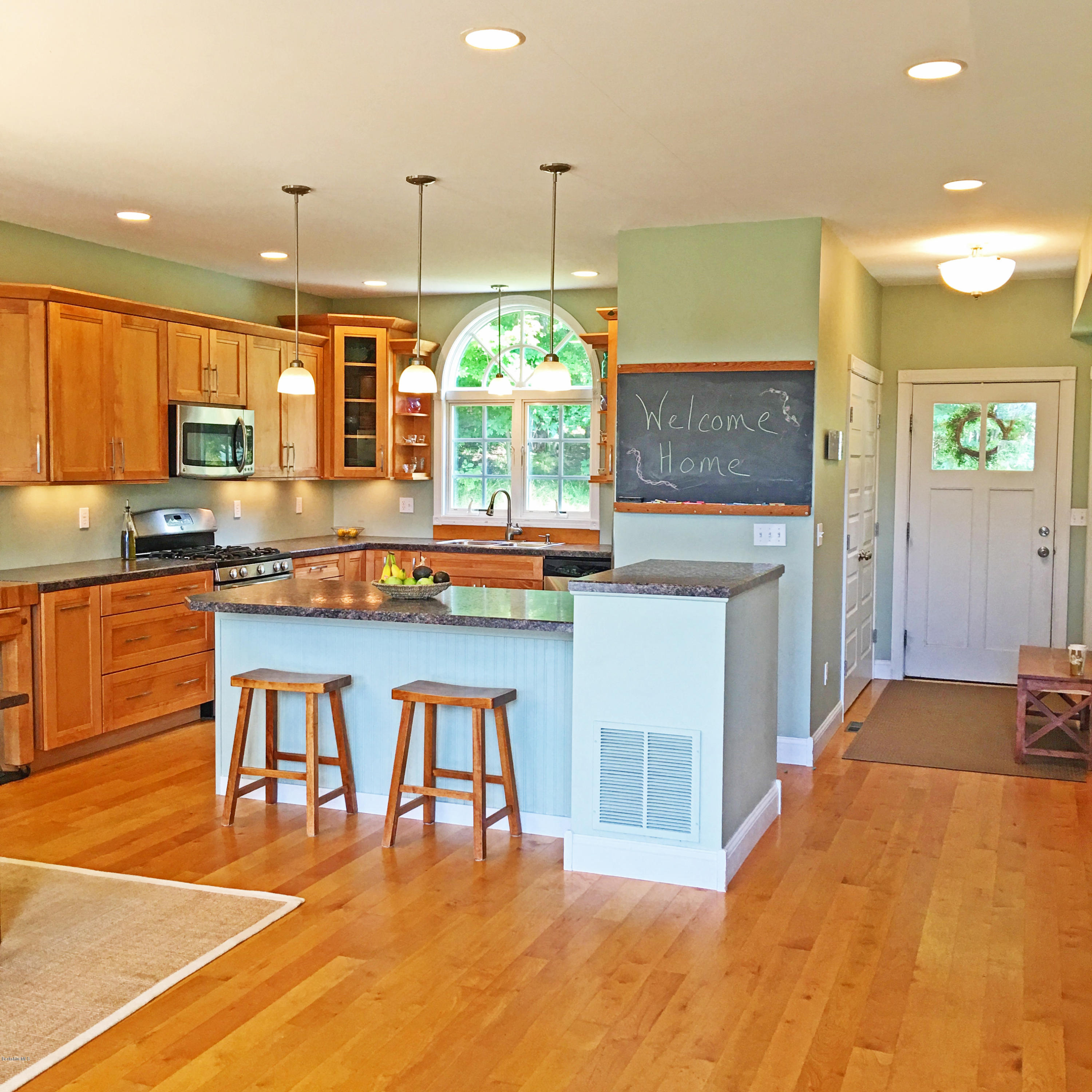93 Stebbins Road Otis, MA 01253 - Photo 11 of 41 a kitchen with stainless steel appliances granite countertop a stove a sink and a refrigerator