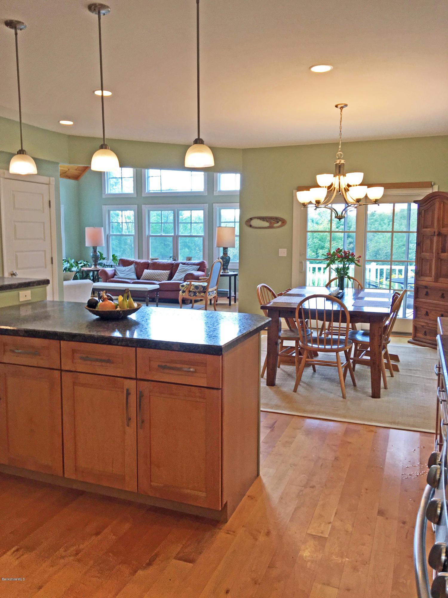 93 Stebbins Road Otis, MA 01253 - Photo 13 of 41 a view of a dining room and livingroom with furniture large windows a chandelier