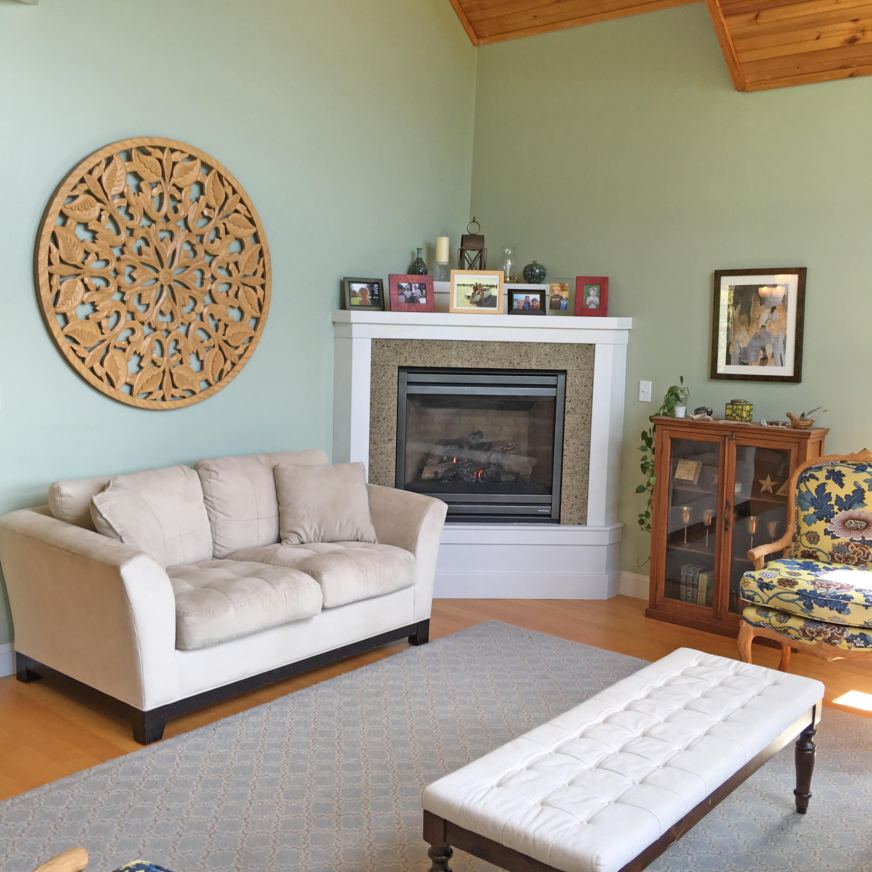 93 Stebbins Road Otis, MA 01253 - Photo 16 of 41 a living room with furniture a table and a fireplace