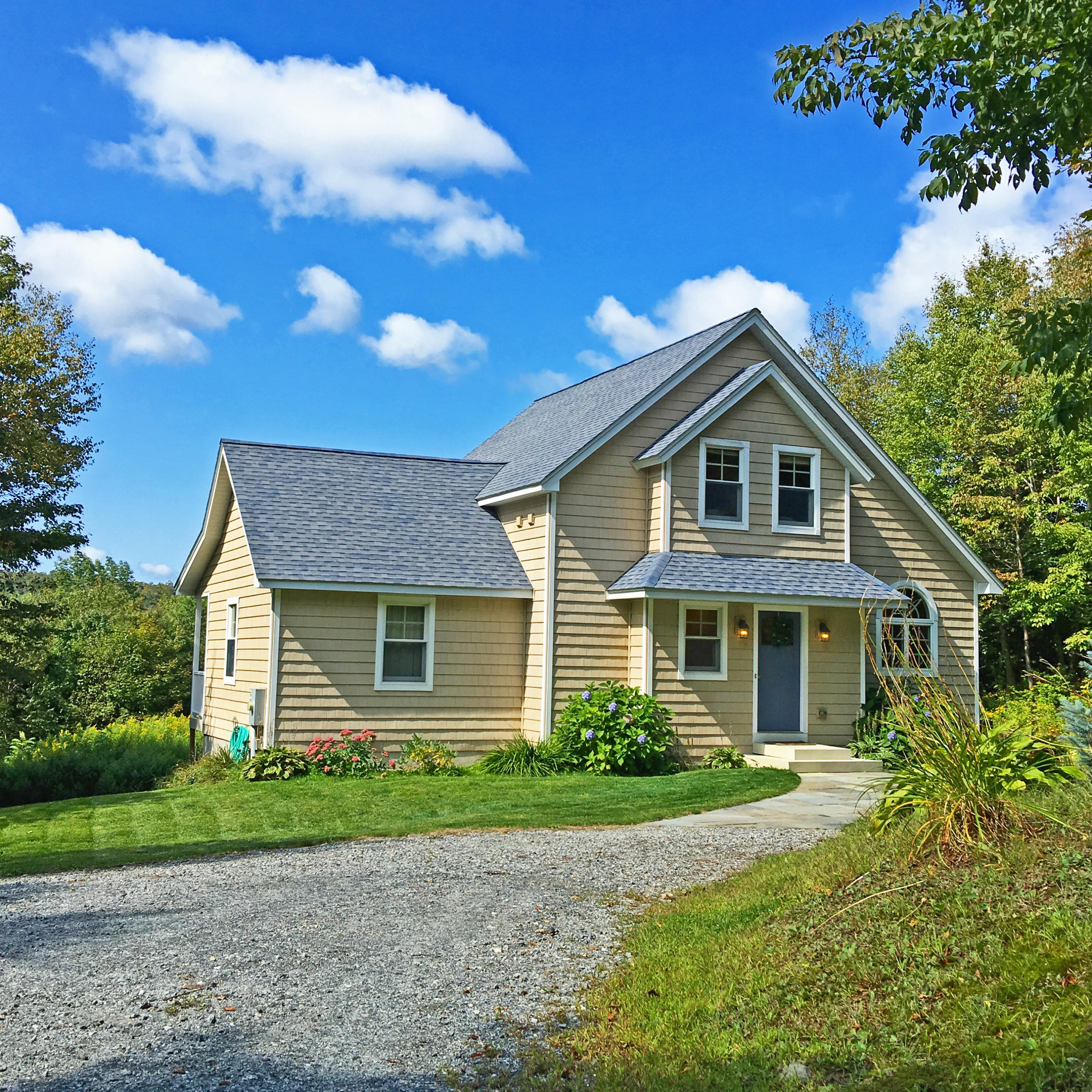 93 Stebbins Road Otis, MA 01253 - Photo 3 of 41 a front view of a house with a yard