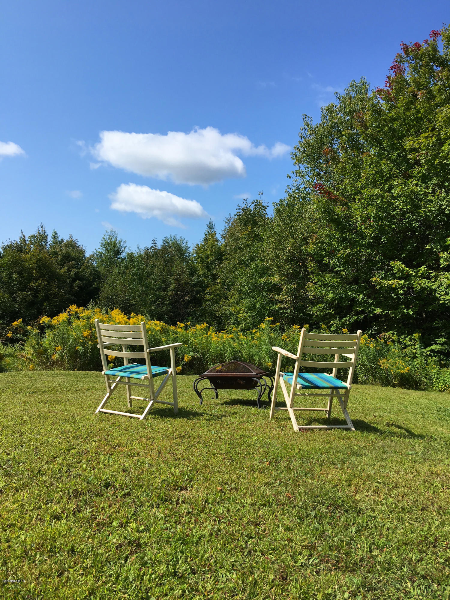 93 Stebbins Road Otis, MA 01253 - Photo 37 of 41 a view of a house with a yard table and chairs