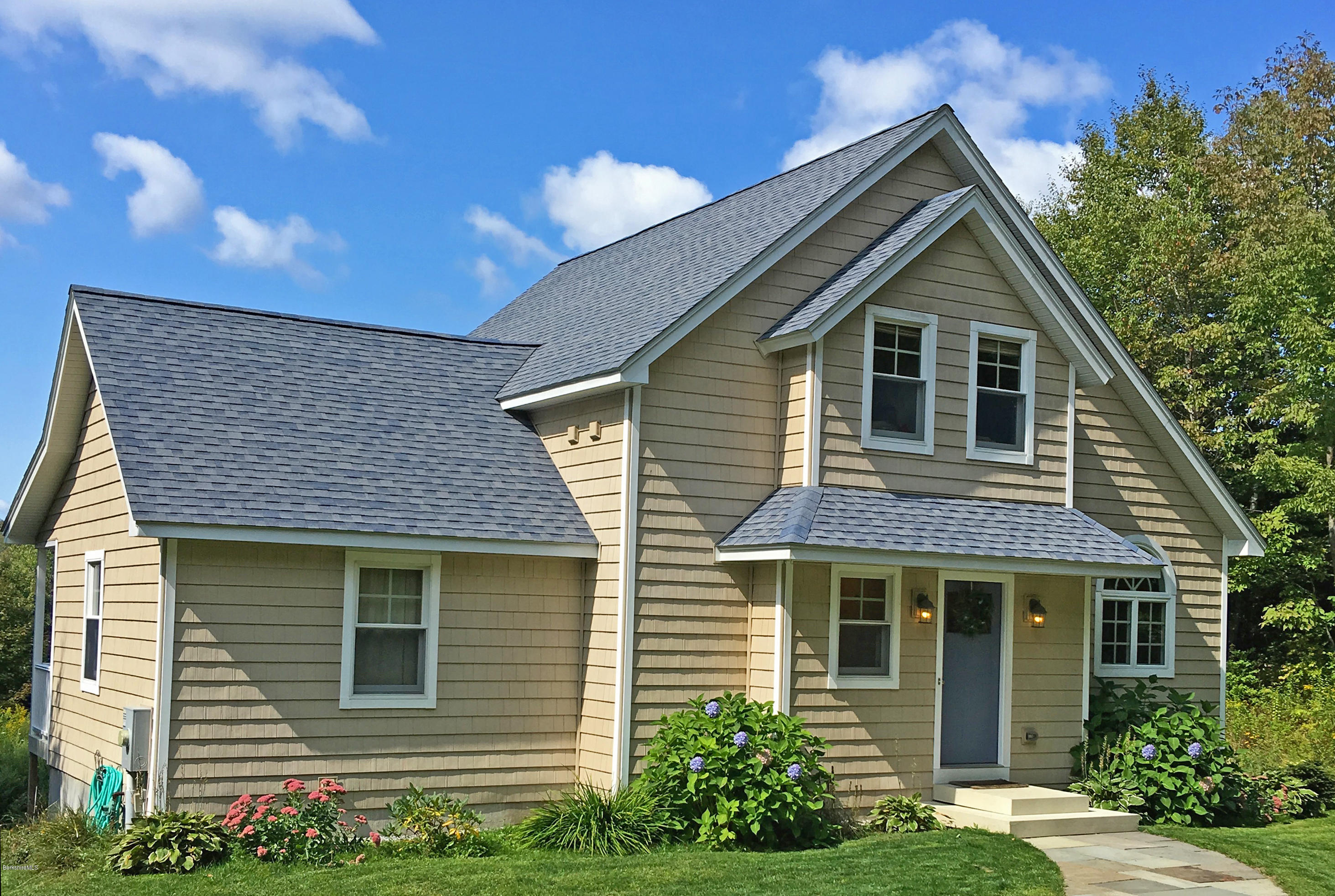 93 Stebbins Road Otis, MA 01253 - Photo 40 of 41 a front view of a house with garden