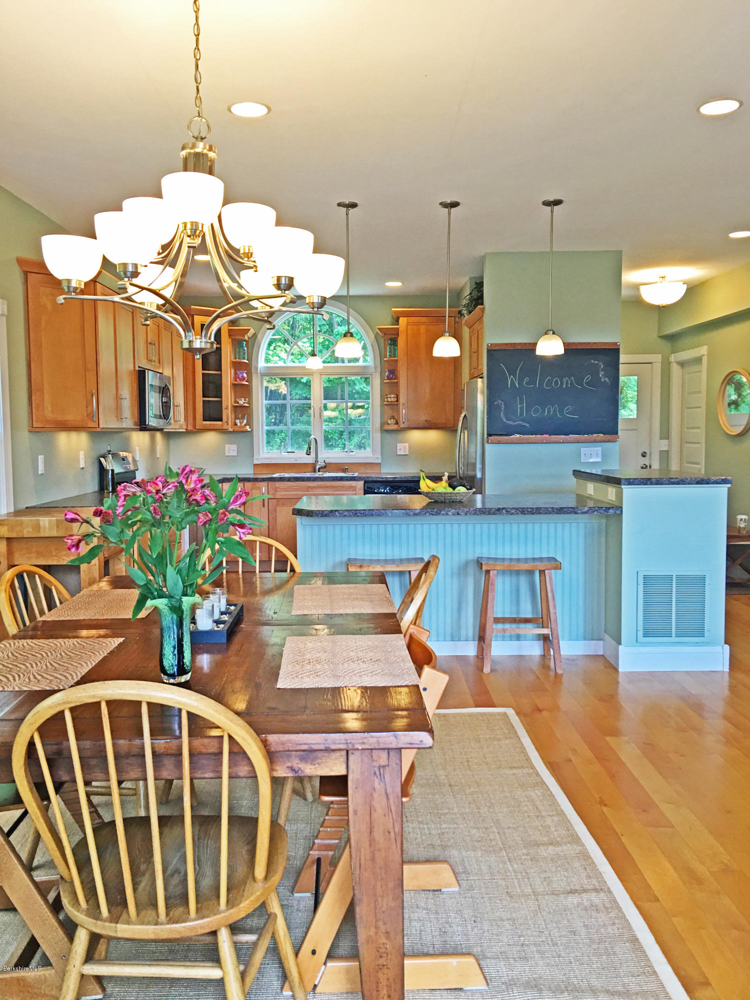 93 Stebbins Road Otis, MA 01253 - Photo 8 of 41 a kitchen with stainless steel appliances granite countertop a stove a sink and a wooden cabinets