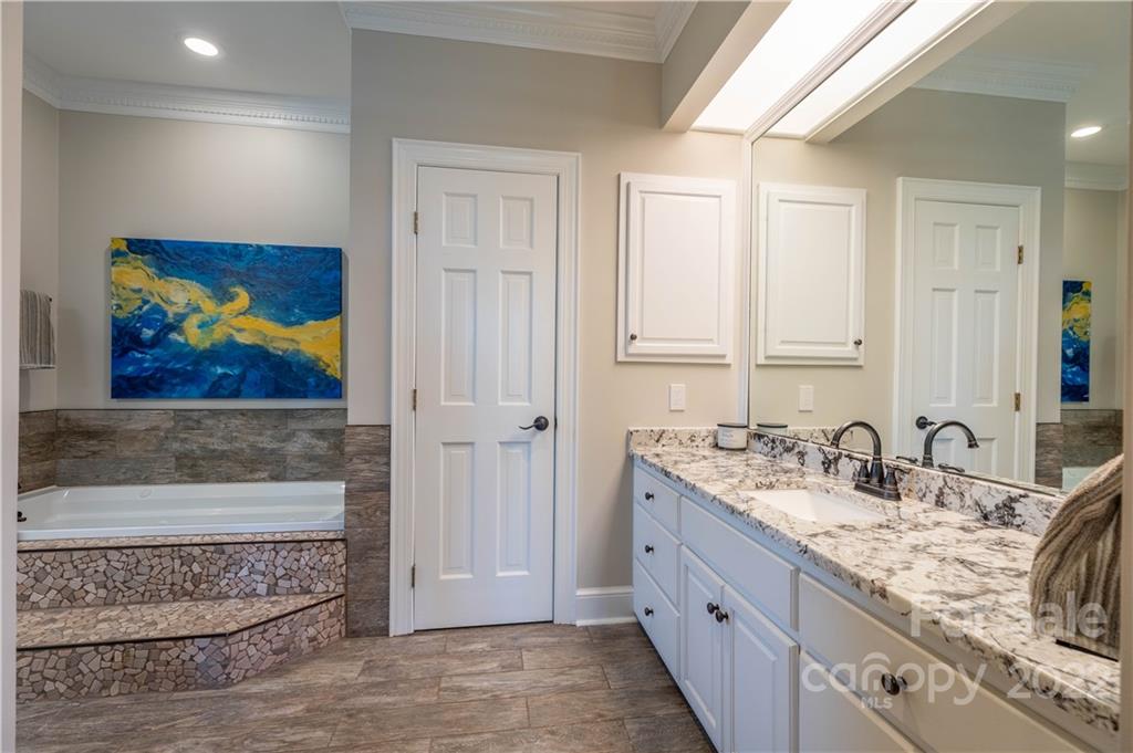 3674 River Road Hickory, NC 28602 - Photo 16 of 48 a spacious bathroom with a double vanity sink and a mirror