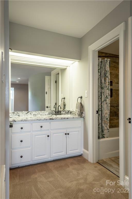 3674 River Road Hickory, NC 28602 - Photo 21 of 48 a bathroom with a granite countertop sink and a mirror