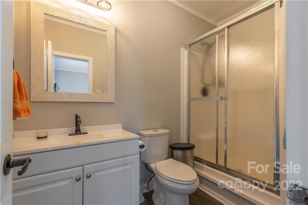 3674 River Road Hickory, NC 28602 - Photo 26 of 48 a bathroom with a sink a toilet and shower