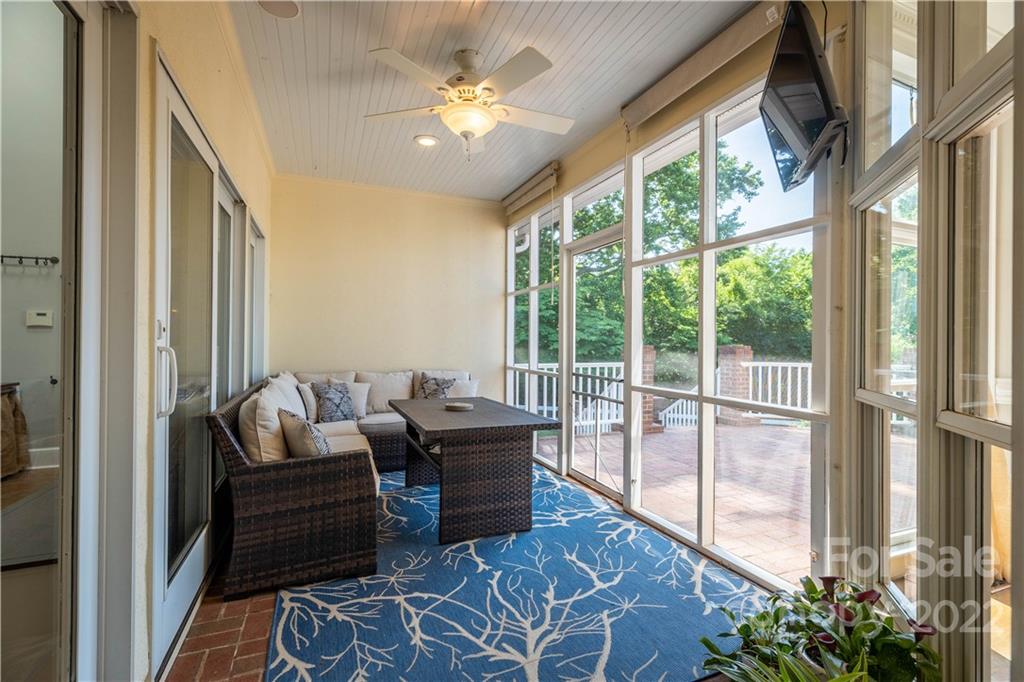 3674 River Road Hickory, NC 28602 - Photo 28 of 48 a living room with furniture and a floor to ceiling window
