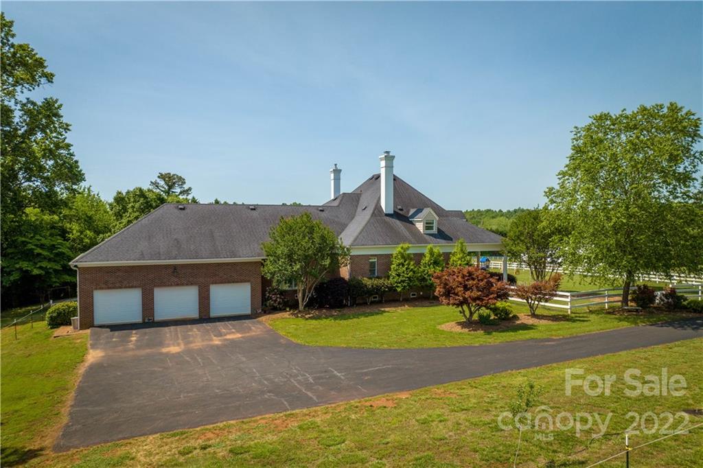 3674 River Road Hickory, NC 28602 - Photo 33 of 48 a front view of a house with a yard and a garden