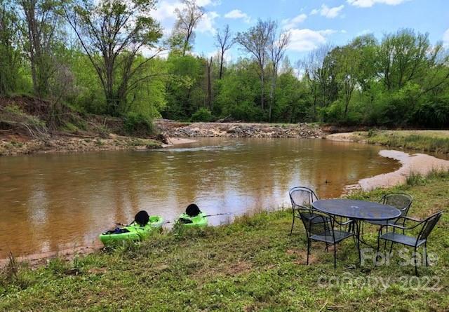 3674 River Road Hickory, NC 28602 - Photo 39 of 48 a view of a lake with a table and chairs