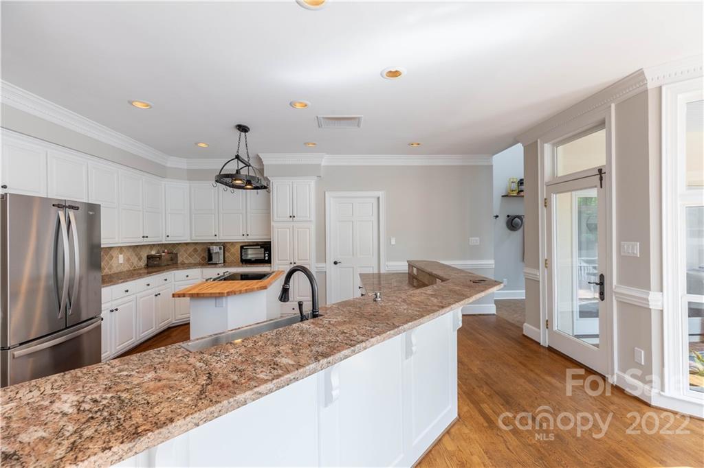 3674 River Road Hickory, NC 28602 - Photo 9 of 48 a kitchen with stainless steel appliances granite countertop a sink refrigerator and cabinets
