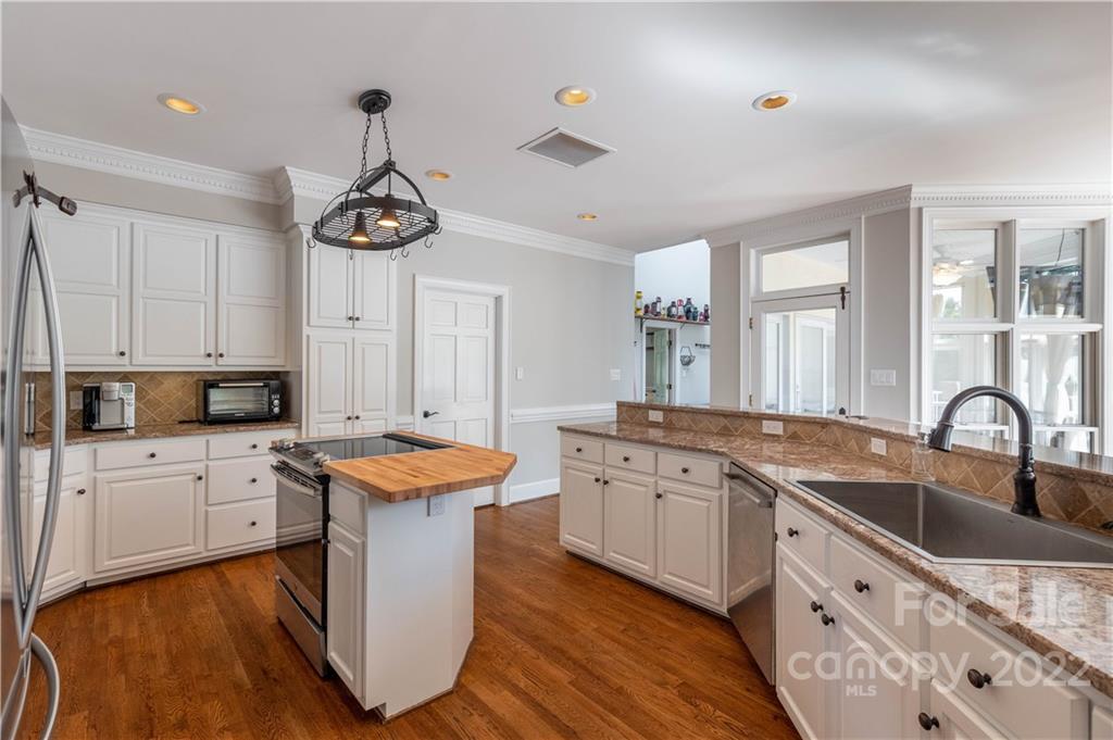 3674 River Road Hickory, NC 28602 - Photo 10 of 48 a kitchen with granite countertop a sink a counter space appliances and cabinets