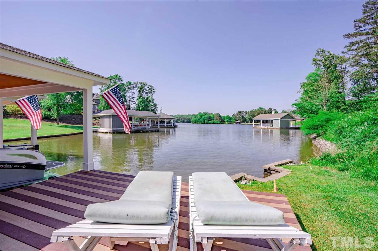 a view of a lake with couches in front of house