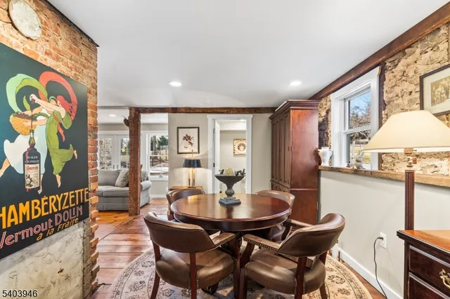 a dining room with furniture a chandelier and wooden floor