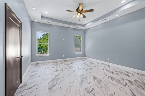 a view of an empty room with window and closet area