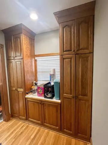 a kitchen with stainless steel appliances granite countertop wooden cabinets and a refrigerator