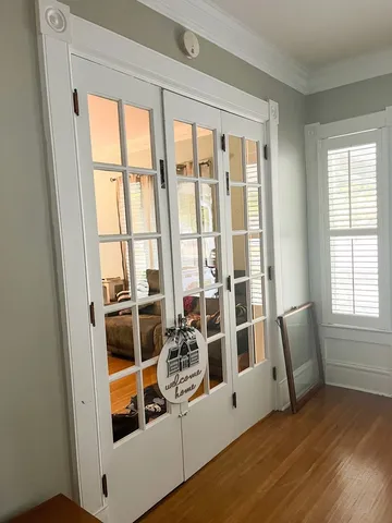 a view of wooden floor and windows in a room