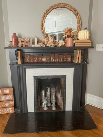 a view of a living room with a fireplace and wooden floor
