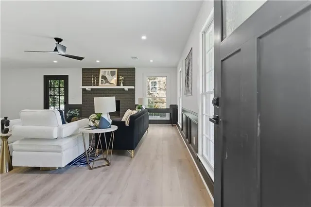 a living room with furniture and a wooden floor