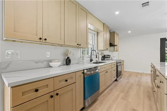 a kitchen with granite countertop white cabinets and white appliances