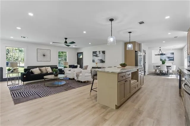 a living room with furniture and a wooden floor