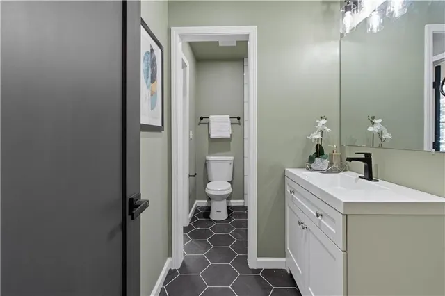 a living room with furniture a fireplace and a wooden floor