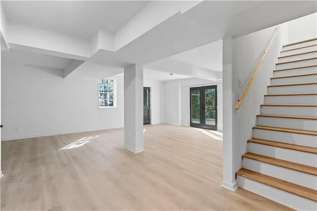 a view of a hallway with wooden floor and cabinet