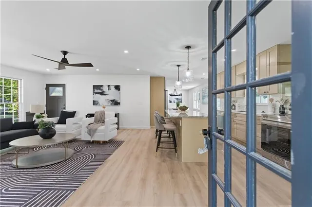 a living room with furniture wooden floor and a table