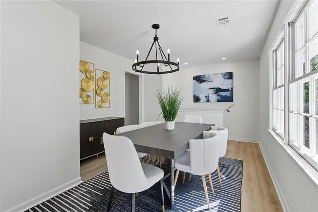 a view of a dining room with furniture window and wooden floor