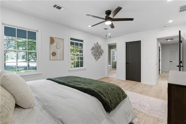 a bedroom with a large bed and a large window