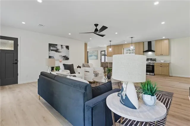 a living room with furniture and kitchen view