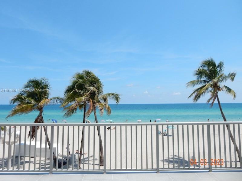 400 North Surf Road, Unit 303 Hollywood, FL 33019 - Photo 1 of 17 a view of outdoor space with deck and trees