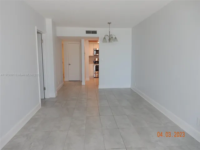 a view of a hallway with wooden shelves