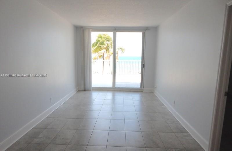 400 North Surf Road, Unit 303 Hollywood, FL 33019 - Photo 3 of 17 a view of an empty room and window