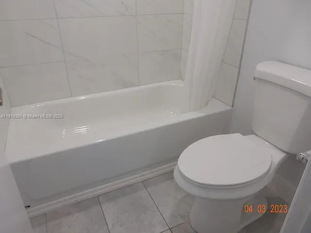 a bathroom with a toilet and a bathtub