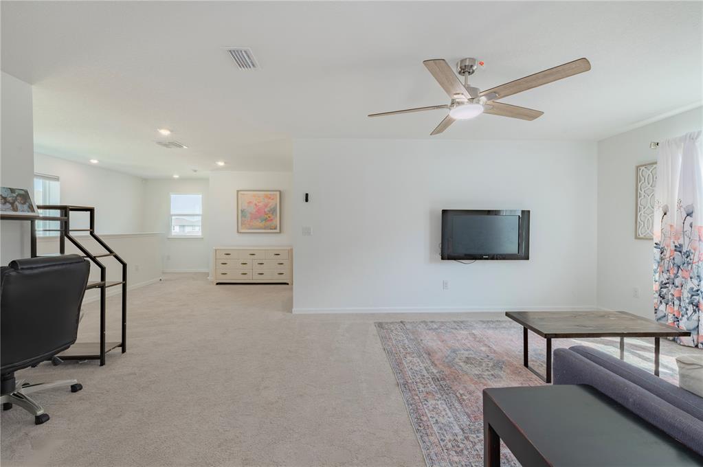 20864 Cherry River Road Land O' Lakes, FL 34638 - Photo 19 of 48 a living room with furniture and a flat screen tv