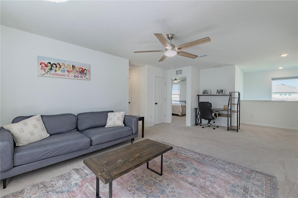 20864 Cherry River Road Land O' Lakes, FL 34638 - Photo 20 of 48 a living room with furniture and kitchen view
