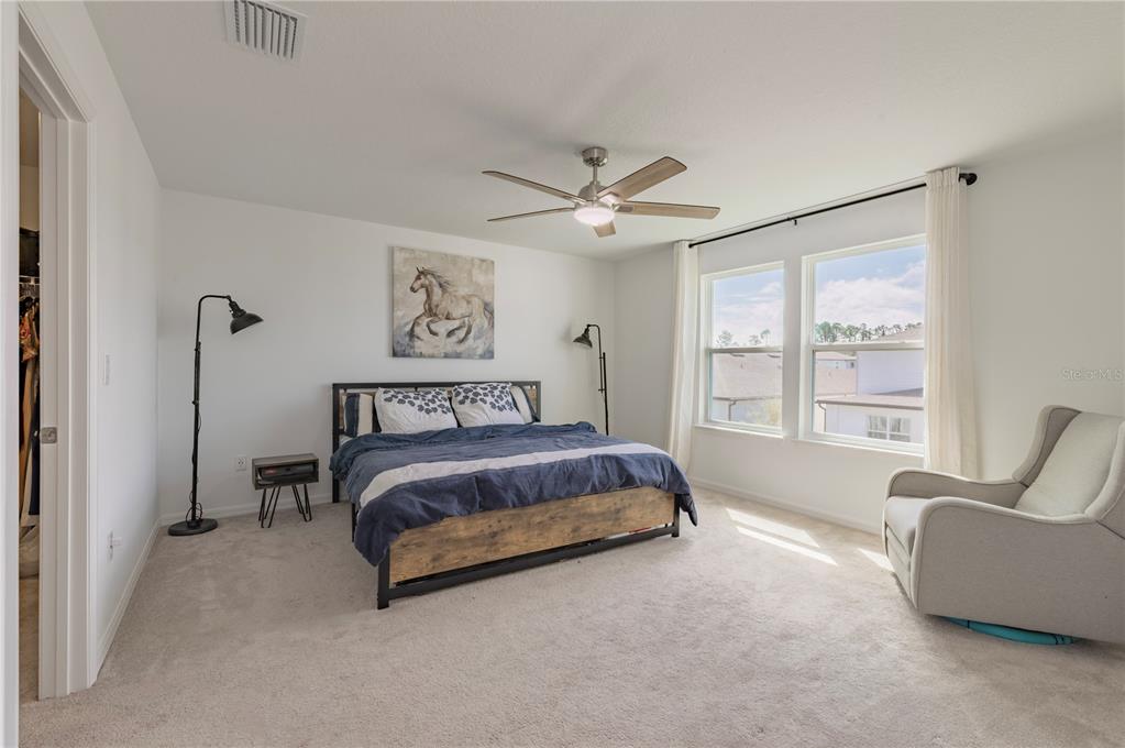 20864 Cherry River Road Land O' Lakes, FL 34638 - Photo 22 of 48 a spacious bedroom with a bed and furniture with a large window