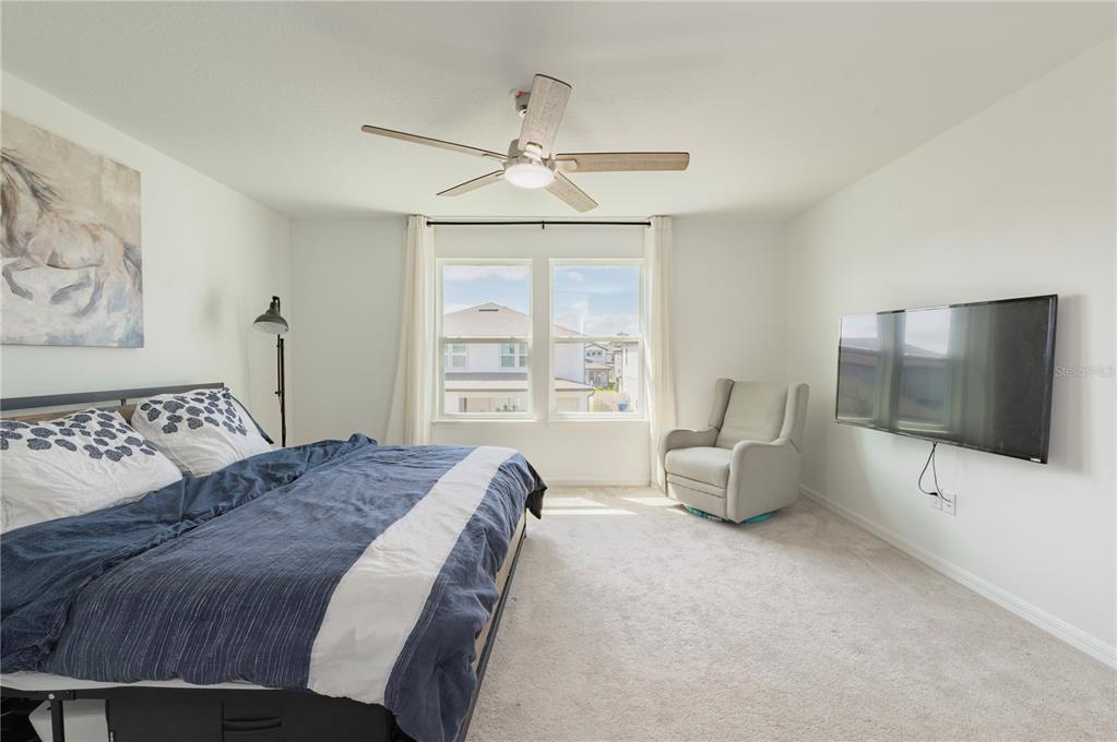 20864 Cherry River Road Land O' Lakes, FL 34638 - Photo 23 of 48 a spacious bedroom with a bed and glass windows