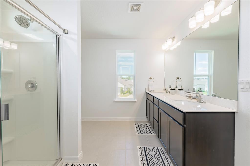 20864 Cherry River Road Land O' Lakes, FL 34638 - Photo 25 of 48 a bathroom with a sink a toilet and shower