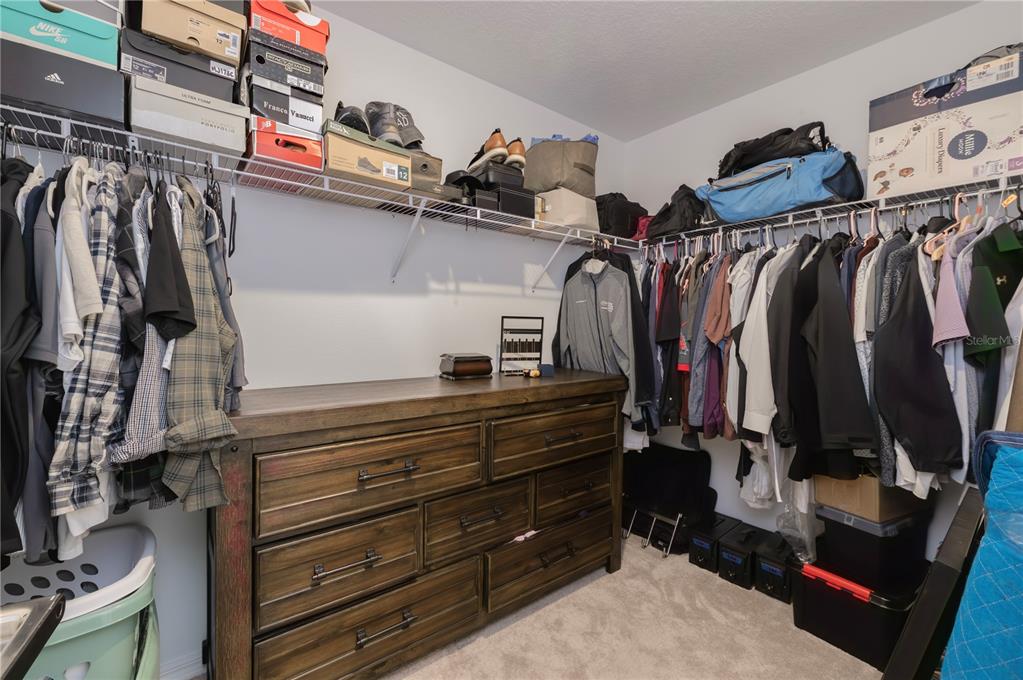 20864 Cherry River Road Land O' Lakes, FL 34638 - Photo 27 of 48 a view of walk in closet with clothes and shoes