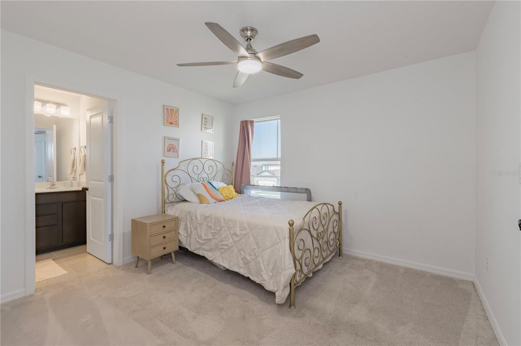 20864 Cherry River Road Land O' Lakes, FL 34638 - Photo 29 of 48 a bedroom with a bed and a ceiling fan