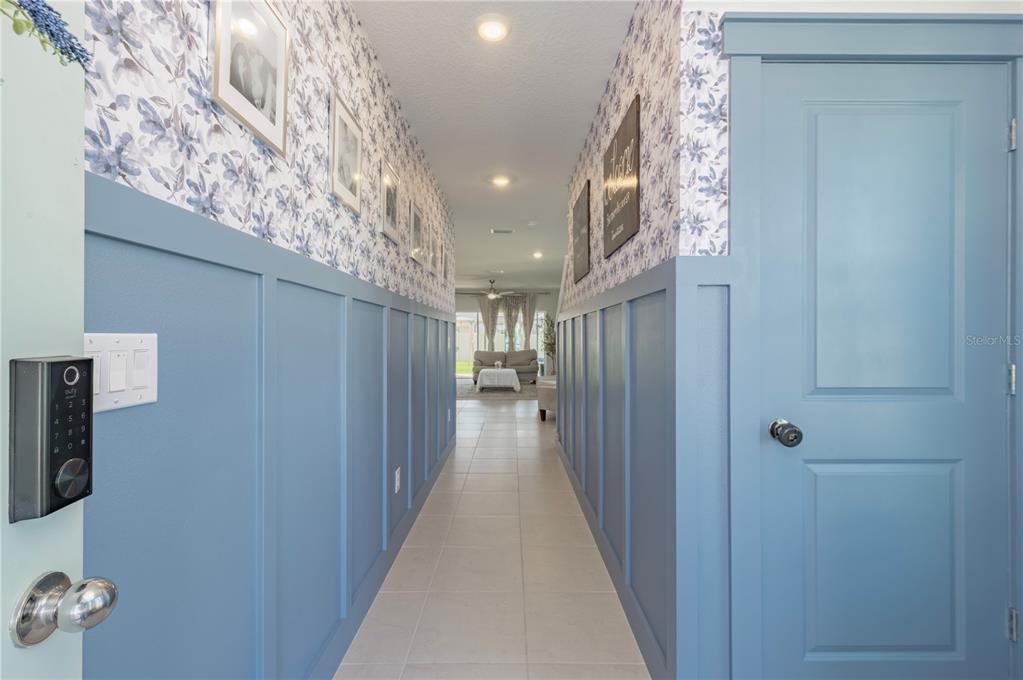 20864 Cherry River Road Land O' Lakes, FL 34638 - Photo 7 of 48 a view of a hallway with wooden floor and a chandelier