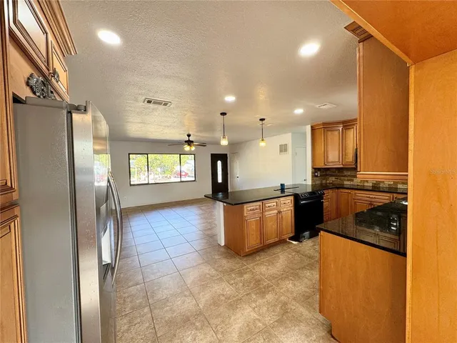 a view of a kitchen with a sink and a window
