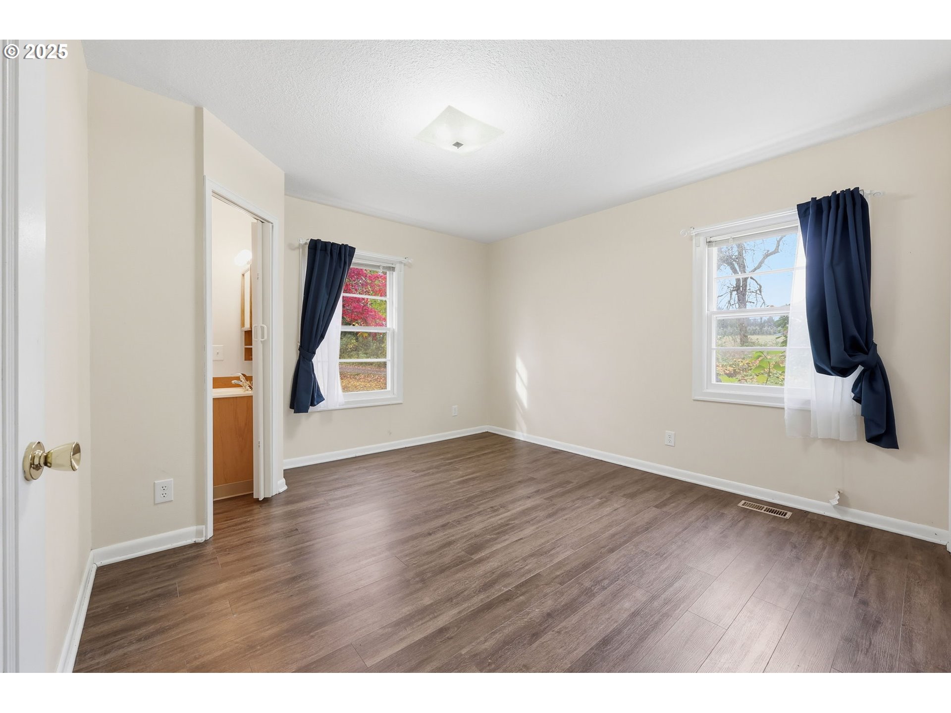 11040 Southeast McCreary Lane Boring, OR 97009 - Photo 15 of 38 a view of an empty room with wooden floor and a window