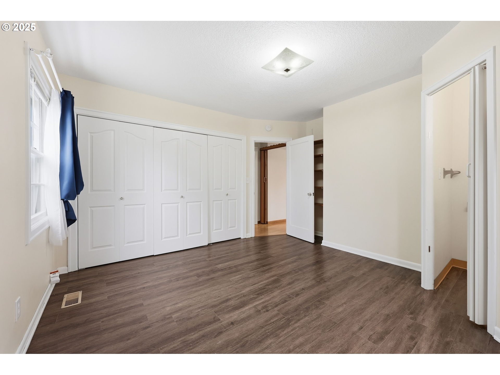 11040 Southeast McCreary Lane Boring, OR 97009 - Photo 16 of 38 a view of an empty room with wooden floor and a window