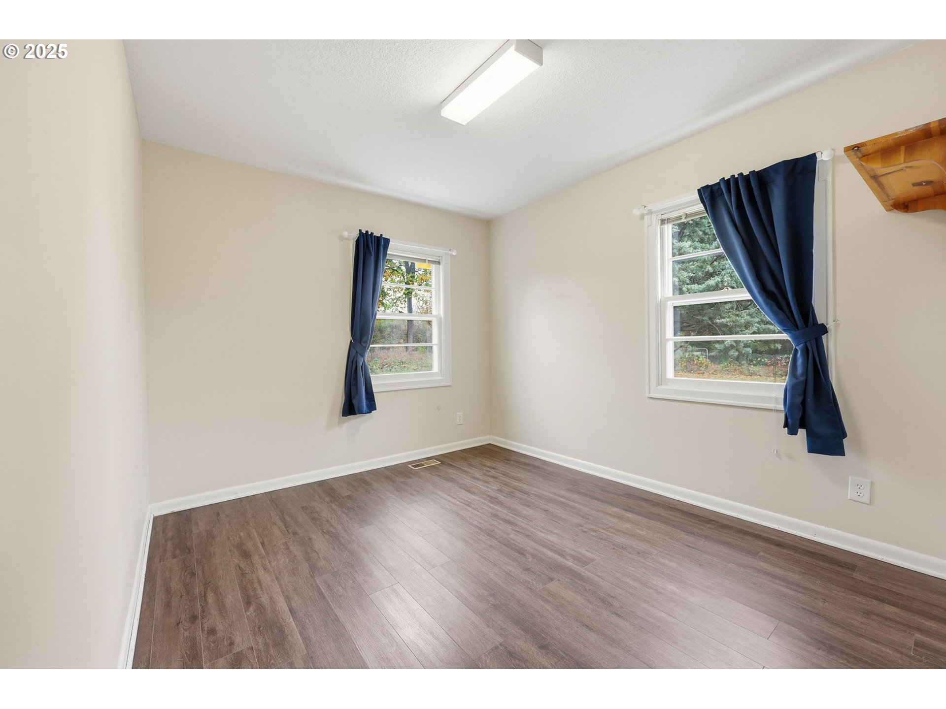 11040 Southeast McCreary Lane Boring, OR 97009 - Photo 18 of 38 a view of an empty room with wooden floor and a window
